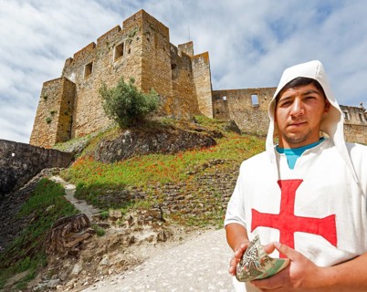 Brochure distributor dressed as Knights Templar in front of the castle, Fortress of Tomar, Castle