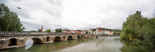 Renaissance bridge Ponte Velha over the Nabao near the old town of Tomar with the Convento de
