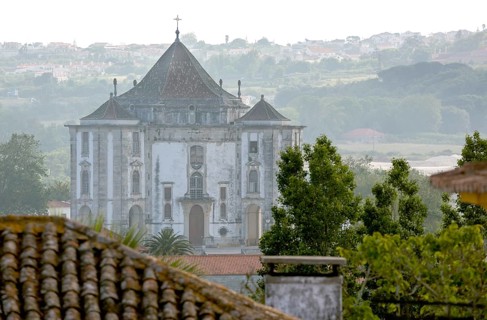 Picturesque small town of Obidos, view of the church in front of the city walls of Óbidos, Leiria