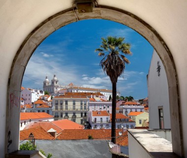 View over the red roofs and through an archway of Lisbon to the Cathedral SÃ©, Lisbon, Lisbon