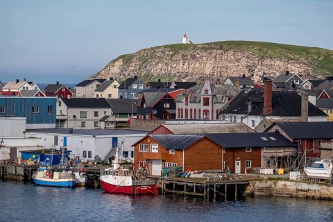 Fishing boats in the harbour, Vardø fyr on the island of Hornøya, lighthouse, Vardø, Finnmark,