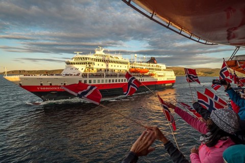 Tourists at the ship's railing, ship MS Finnmarken, Norwegian flags, Mehamn, Finnmark, Norway,