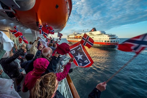 Tourists at the ship's railing, ship MS Finnmarken, Norwegian flags, Mehamn, Finnmark, Norway,