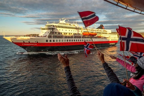 Tourists at the ship's railing, ship MS Finnmarken, Norwegian flags, Mehamn, Finnmark, Norway,