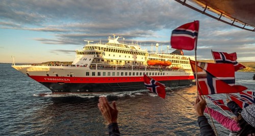 Tourists at the ship's railing, ship MS Finnmarken, Norwegian flags, Mehamn, Finnmark, Norway,
