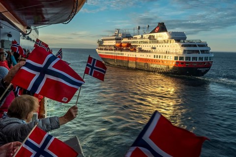 Tourists at the ship's railing, ship MS Finnmarken, Norwegian flags, Mehamn, Finnmark, Norway,