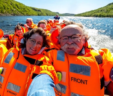 Selfie, tourists with life jackets, river trip with tourists on an excursion boat in a headwind,