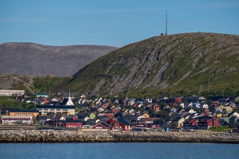 View of village with church in front of mountain range, Kjøllefjord, Finnmark, Norway, Scandinavia,