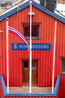 Red Norwegian house with town sign, Måsøy, Finnmark, Norway, Scandinavia, Europe, adventure trip,