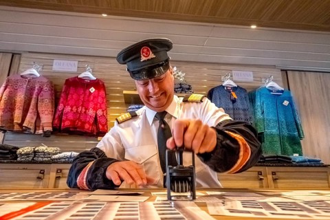 Crew member stamps the mail on the mailboat, postman, ship officer, postal employee, postcard