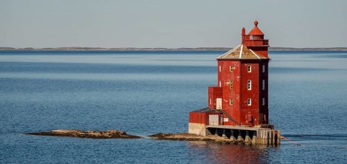 Kjeungskjær Fyr, red lighthouse, off the Norwegian coast on a small archipelago off Ã˜rland,
