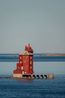 Kjeungskjær Fyr, red lighthouse, off the Norwegian coast on a small archipelago off Ã˜rland,