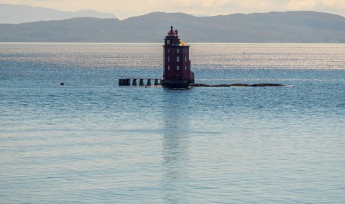 Kjeungskjær Fyr, red lighthouse, off the Norwegian coast on a small archipelago off Ã˜rland,