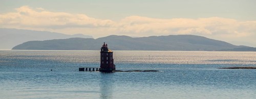 Kjeungskjær Fyr, red lighthouse, off the Norwegian coast on a small archipelago off Ã˜rland,