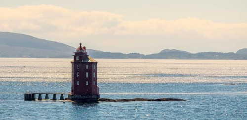 Kjeungskjær Fyr, red lighthouse, off the Norwegian coast on a small archipelago off Ã˜rland,