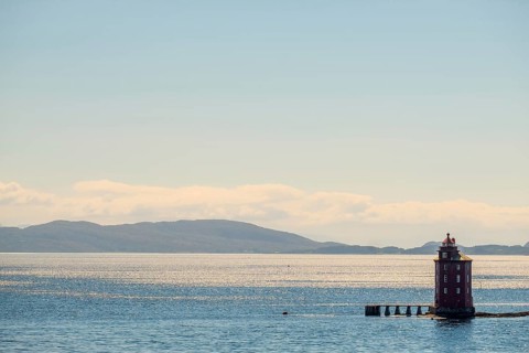 Kjeungskjær Fyr, red lighthouse, off the Norwegian coast on a small archipelago off Ã˜rland,