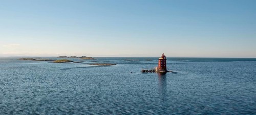 Kjeungskjær Fyr, red lighthouse, off the Norwegian coast on a small archipelago off Ã˜rland,