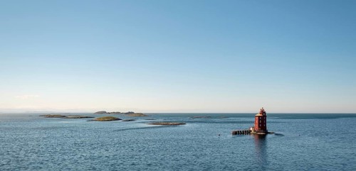 Kjeungskjær Fyr, red lighthouse, off the Norwegian coast on a small archipelago off Ã˜rland,