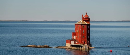 Kjeungskjær Fyr, red lighthouse, off the Norwegian coast on a small archipelago off Ã˜rland,