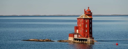 Kjeungskjær Fyr, red lighthouse, off the Norwegian coast on a small archipelago off Ã˜rland,