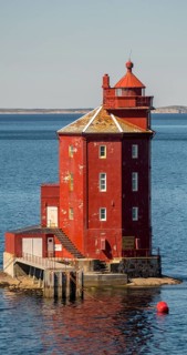 Kjeungskjær Fyr, red lighthouse, off the Norwegian coast on a small skerry off Ørland, Trøndelag