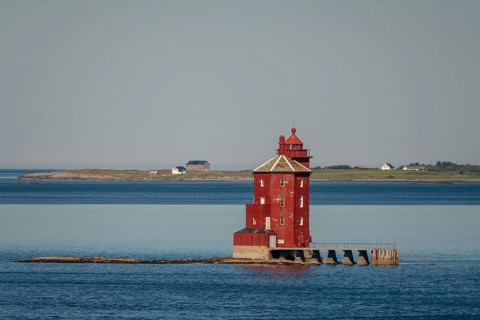 Kjeungskjær Fyr, red lighthouse, off the Norwegian coast on a small archipelago off Ã˜rland,