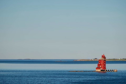 Kjeungskjær Fyr, red lighthouse, off the Norwegian coast on a small archipelago off Ã˜rland,