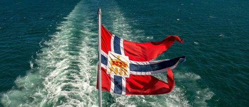 The post symbol on Norwegian flag of a Hurtigruten ship, foaming spray, Trondheimfjord, Agdenes,