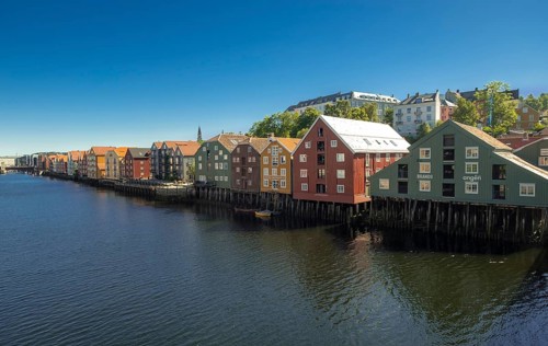 Picturesque colourful residential houses and commercial buildings on the river Nidelva, pile
