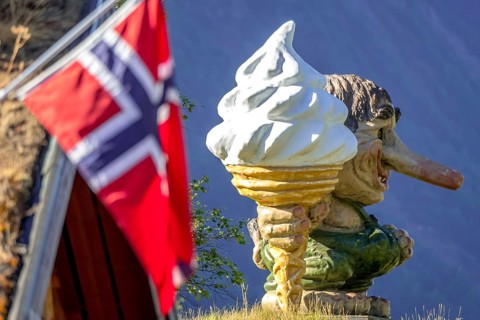 Norwegian troll with ice cream and Norwegian flag, Innfjorden, Møre og Romsdal, Norway,
