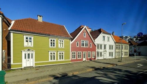 Colourful row of wooden houses in the city of Bergen, street with traffic lights, street lamp,