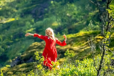 Woman dressed in red is a Huldra, fairy, legendary figure, Kjosfossen waterfall, waterfall near