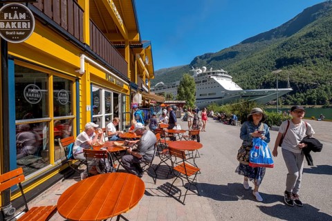 Tourists in Flåm, FABRIK KUTSALG FACTORY OUTLET, café, yellow wooden house, excursion ship, fjord,