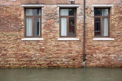 Venice, Italy - 2 September 2025: The water in a canal is seen in front of a hotel during the 82nd