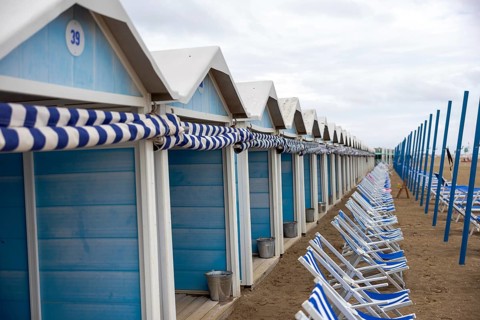 Venice, Italy - 2 September 2025: Beach chairs and cabins on the Lido beach during the 82nd Venice