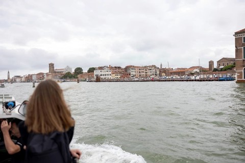 Venice, Italy - 2 September 2025: A woman takes a photo with her mobile phone on the way to the