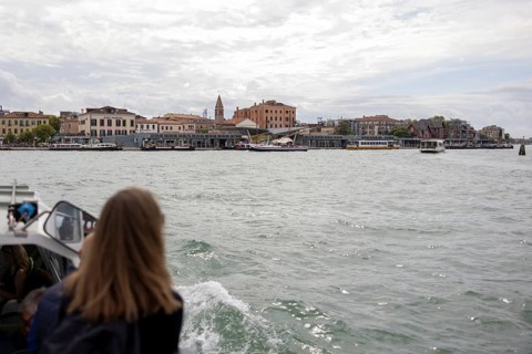 Venice, Italy - 2 September 2025: A woman takes a photo with her mobile phone on the way to the
