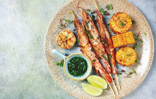 Langoustines on skewers, shrimp kebab, with fried corn, spices and herbs, homemade, no people