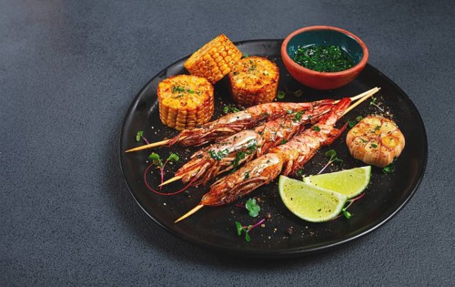 Langoustines on skewers, shrimp kebab, with fried corn, spices and herbs, homemade, no people