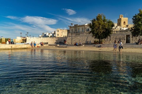 City beach Spiaggetta del Molo or Spiaggia dei Bambini and the old town centre of Otranto, Apulia,