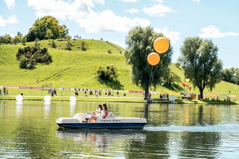 Festival visitors ride a pedal boat at the Superbloom Festival, Day 2 in the Olympic Park, Munich,