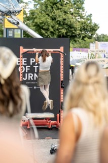 A visitor does pull-ups with make-up at the Superbloom Festival, Day 2 in the Olympic Park, Munich,