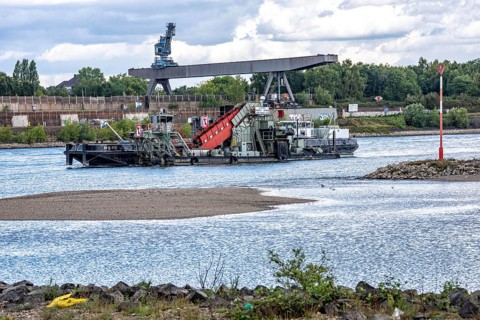 Bucket chain dredger at work on the Rhine near Duisburg, between the Neuenkamper Rhine Bridge and