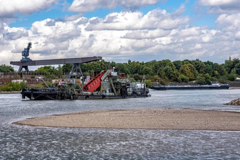 Bucket chain dredger at work on the Rhine near Duisburg, between the Neuenkamper Rhine Bridge and