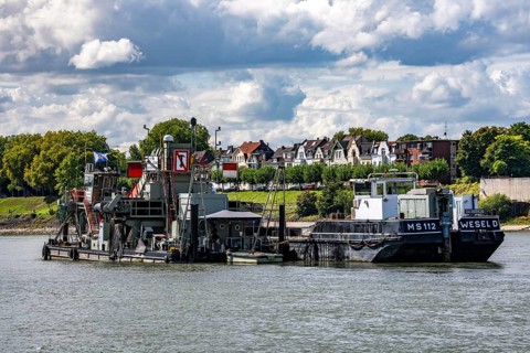 Bucket chain dredger at work on the Rhine near Duisburg, between the Neuenkamper Rhine Bridge and