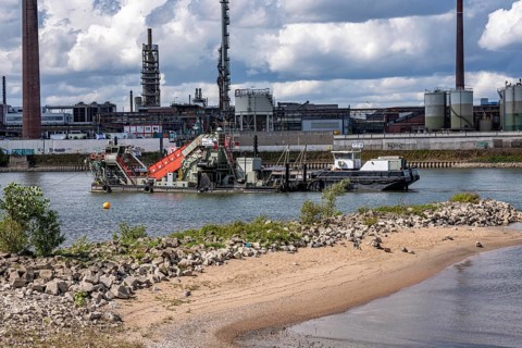 Bucket chain dredger at work on the Rhine near Duisburg, between the Neuenkamper Rhine Bridge and