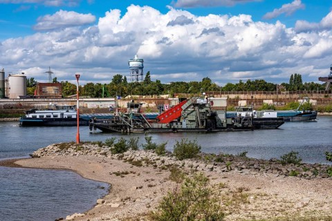 Bucket chain dredger at work on the Rhine near Duisburg, between the Neuenkamper Rhine Bridge and