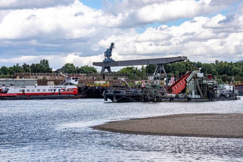 Bucket chain dredger at work on the Rhine near Duisburg, between the Neuenkamper Rhine Bridge and
