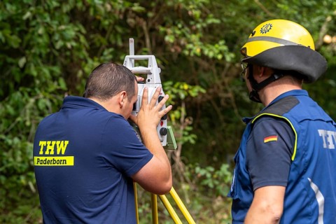 Surveying experts constructing a façade support for a building in danger of collapsing, using the
