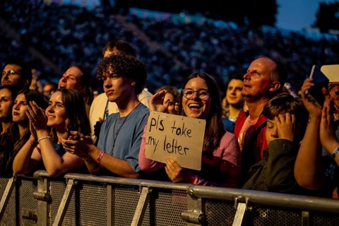 Visitor shows sign at the performance of Raye at the Superbloom Festival, Day 1 at the Olympiapark,